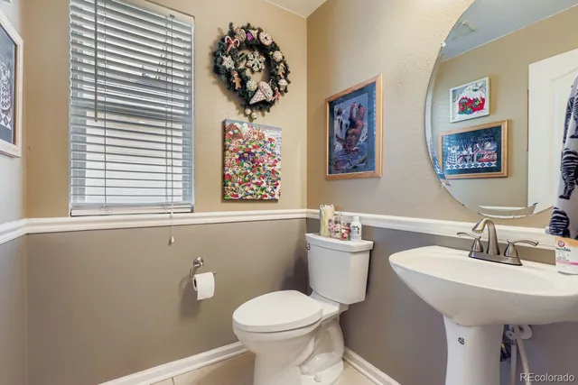 a bathroom with a toilet a sink and a mirror