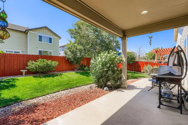 a view of an chairs and table in backyard