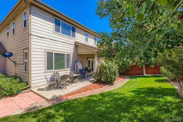 a front view of house with yard and outdoor seating