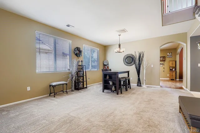 a view of dining room with furniture and a chandelier