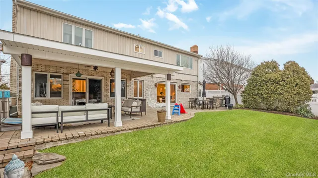 a view of a house with a backyard porch and sitting area