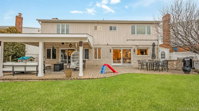 a view of a house with a backyard and a patio