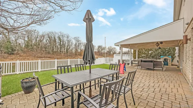 a view of a chairs and table in the patio