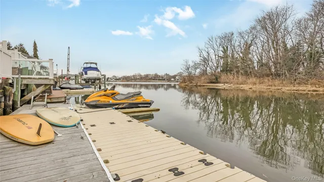 a view of a lake with tables and chairs