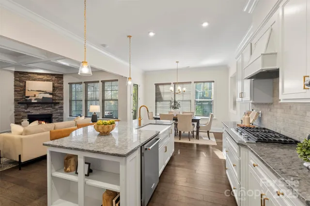 a open kitchen with stainless steel appliances granite countertop a stove and more cabinets