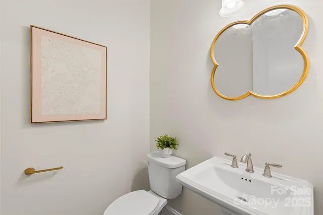 a bathroom with a sink mirror and toilet