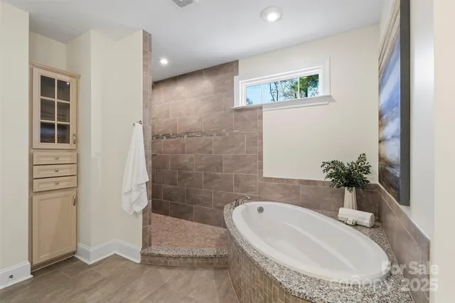a bathroom with a tub and a sink