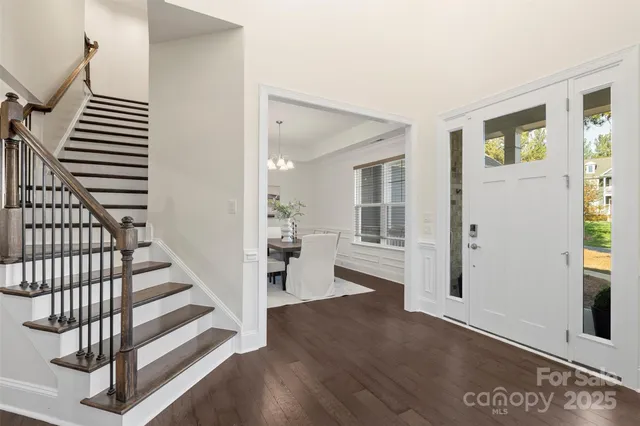 a view of an entryway with wooden floor and a livingroom