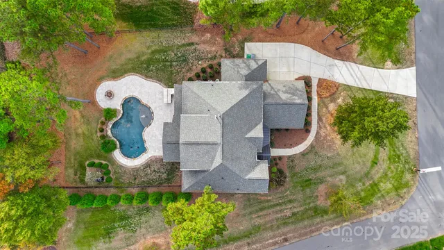 an aerial view of residential house with outdoor space and swimming pool