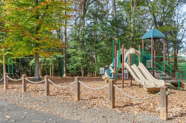 a view of a wooden chairs and backyard