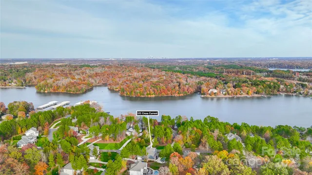 an aerial view of ocean and residential houses with outdoor space