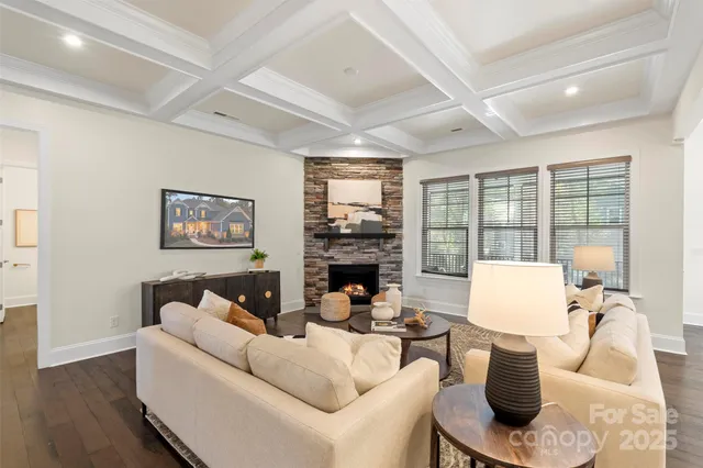 a living room with furniture a fireplace and a large window