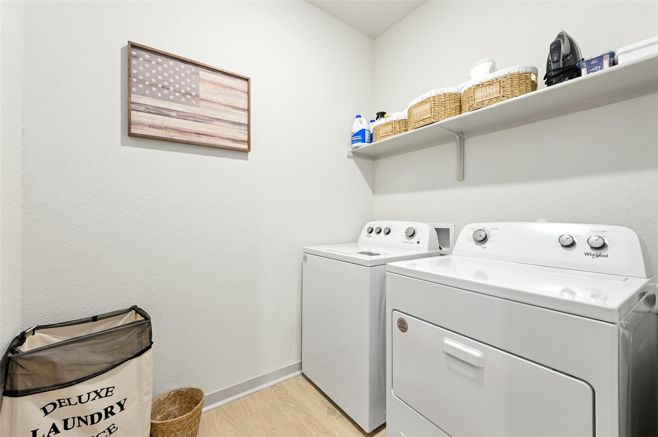 2300 Ranier Court Austin, TX 78754 - Photo 14 of 24 Laundry room with light wood-style floors and washer and dryer