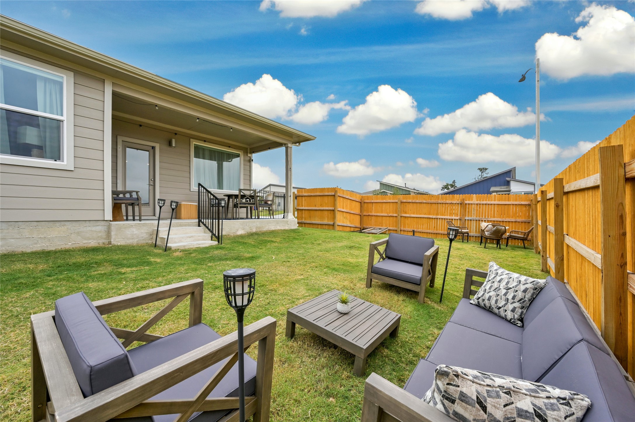 2300 Ranier Court Austin, TX 78754 - Photo 21 of 24 Fenced backyard featuring a patio area and an outdoor living space with a fire pit