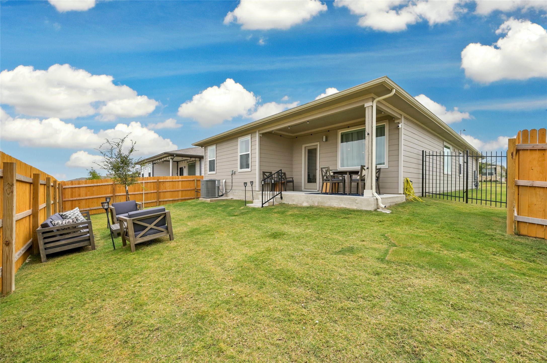 2300 Ranier Court Austin, TX 78754 - Photo 22 of 24 Rear view of house with a fenced backyard and a patio area