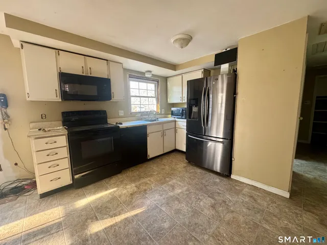 a kitchen with a refrigerator stove and microwave