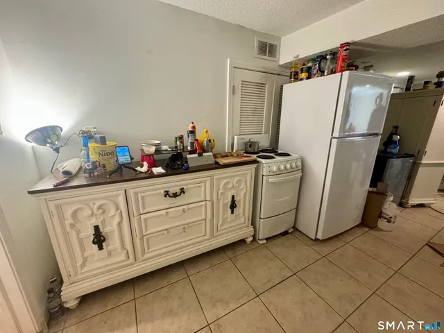 a kitchen with appliances cabinets and a refrigerator