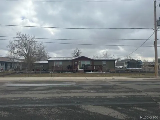 a backyard of a house with yard and outdoor seating