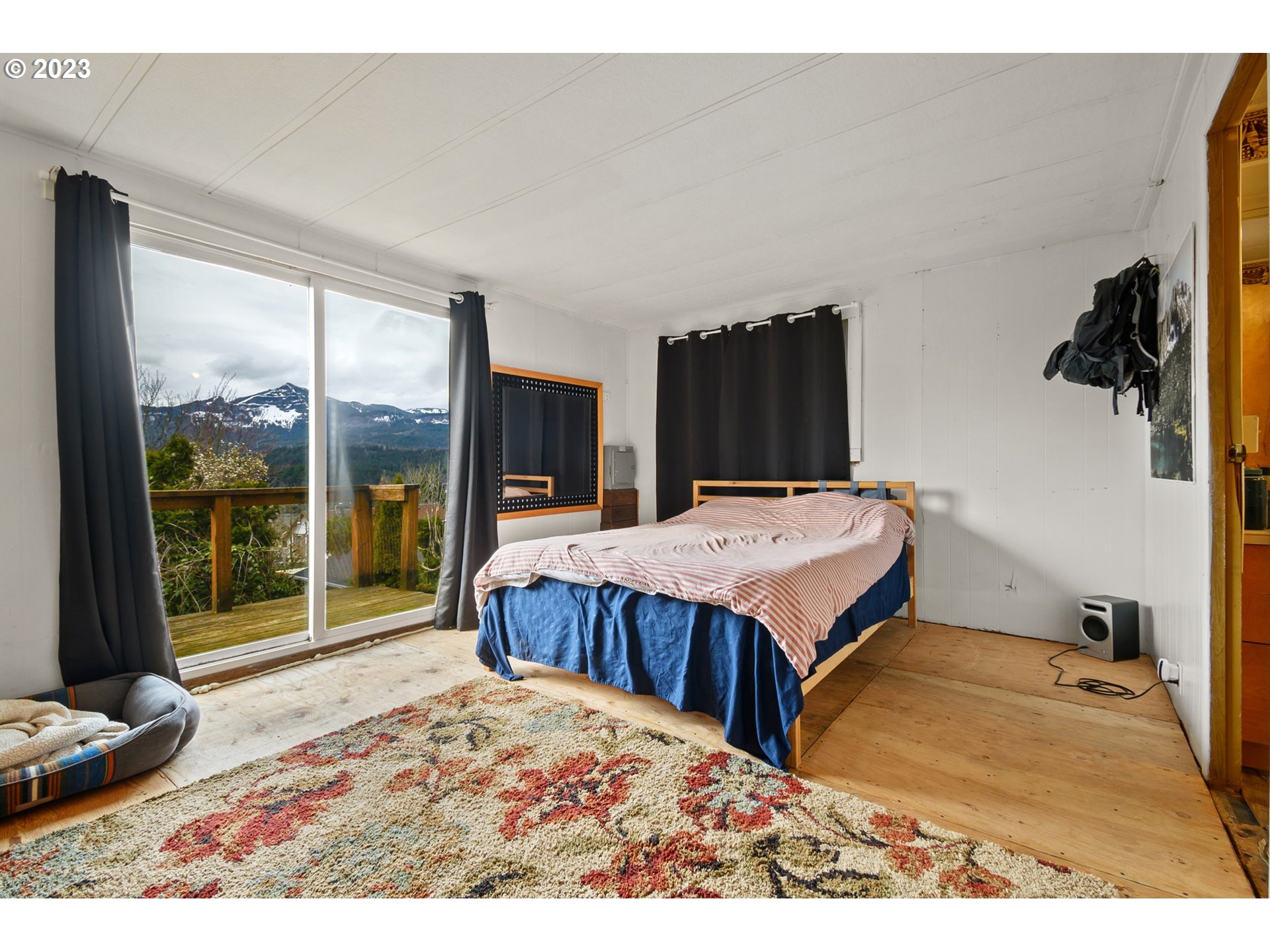126 Southwest Venture Street Cascade Locks, OR 97014 - Photo 8 of 16 a bed sitting in a bedroom next to a window