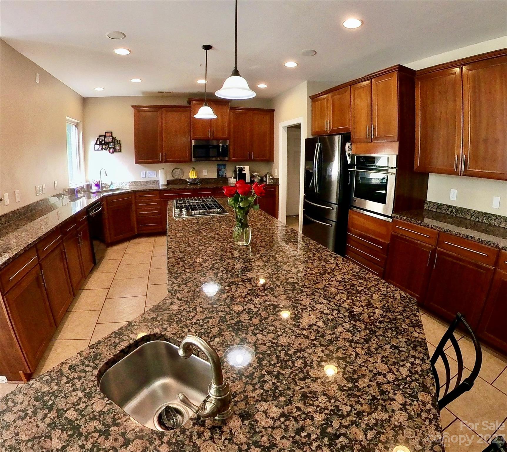 6100 Rehobeth Road Waxhaw, NC 28173 - Photo 18 of 37 a kitchen with stainless steel appliances granite countertop a sink a stove and a refrigerator