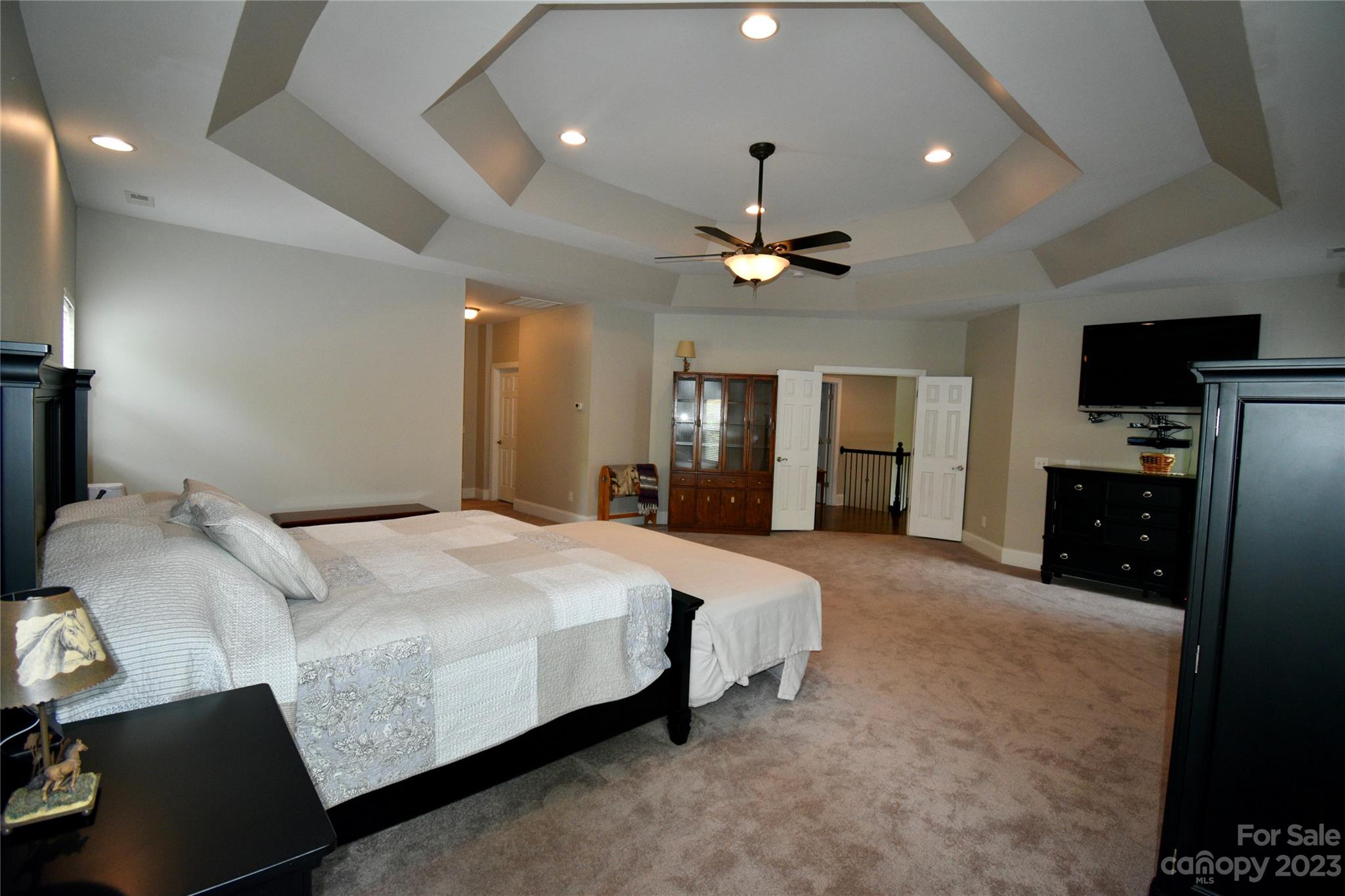 6100 Rehobeth Road Waxhaw, NC 28173 - Photo 23 of 37 a spacious bedroom with a bed and a chandelier