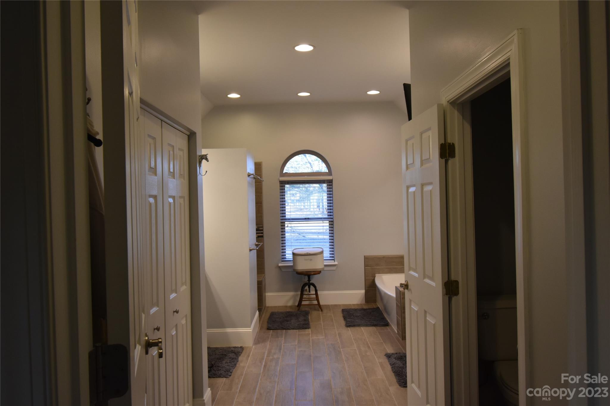 6100 Rehobeth Road Waxhaw, NC 28173 - Photo 25 of 37 a view of a hallway with wooden floor and furniture