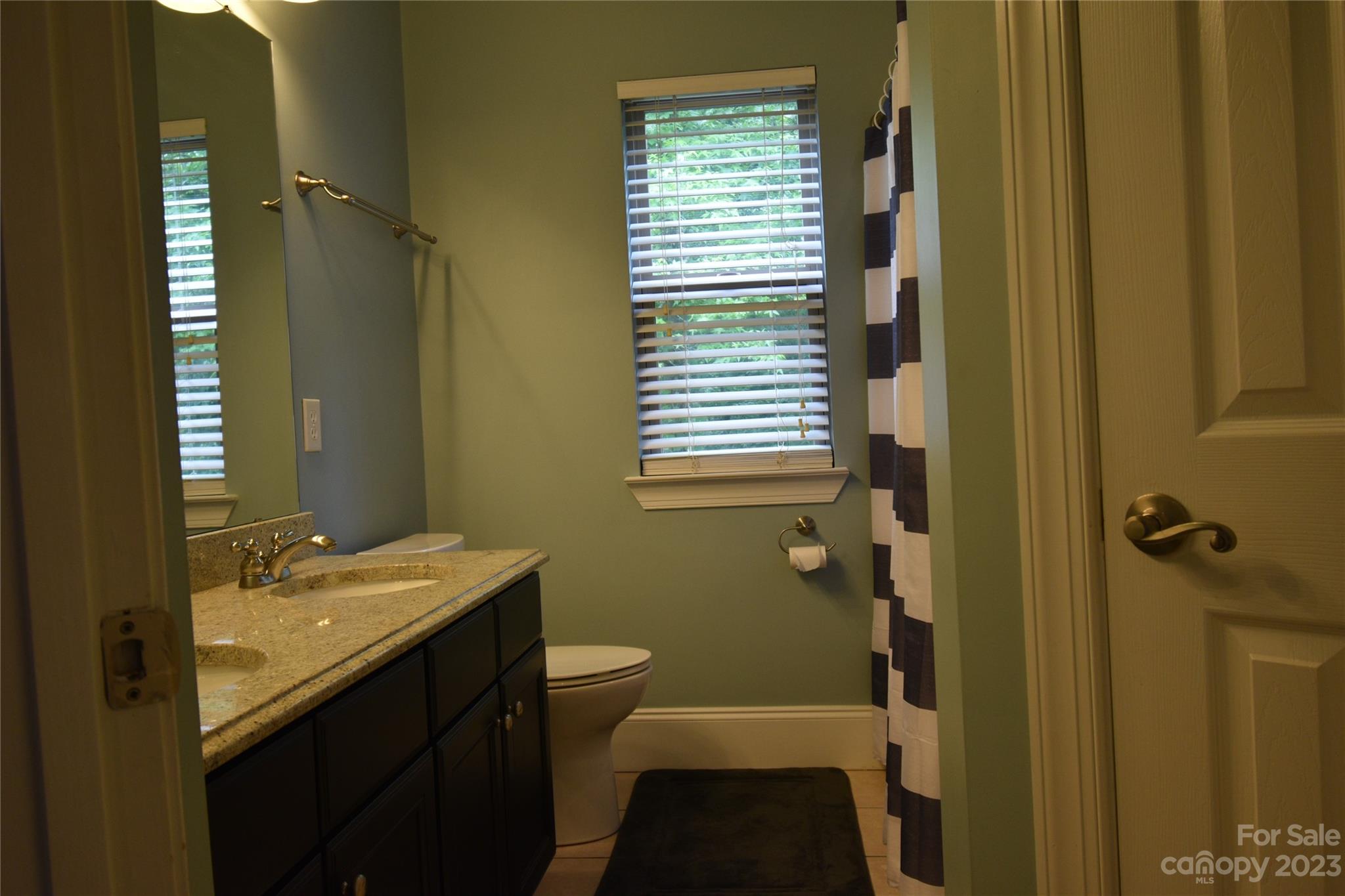 6100 Rehobeth Road Waxhaw, NC 28173 - Photo 32 of 37 a bathroom with a sink a toilet and shower