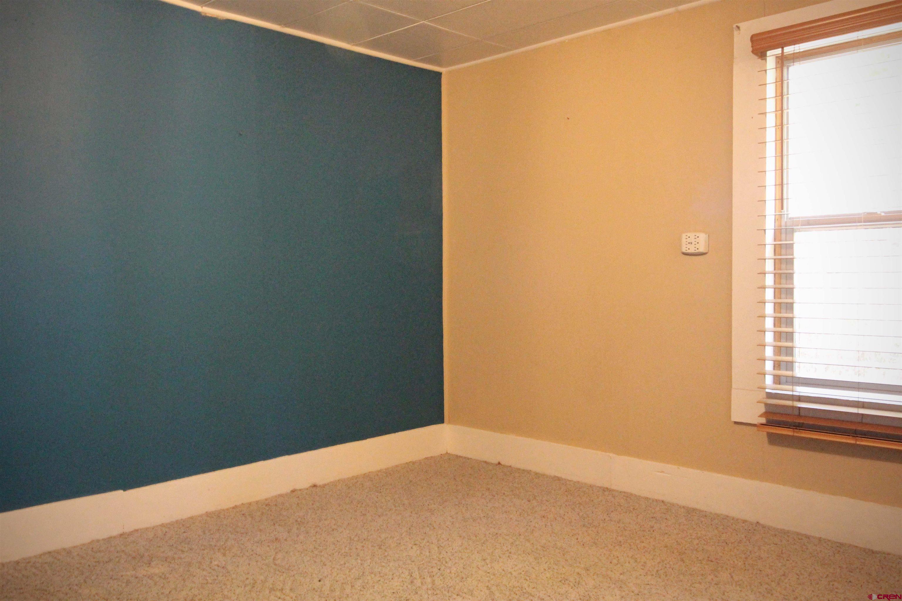 304 South Walnut Street Mancos, CO 81328 - Photo 17 of 31 a view of an empty room with a window