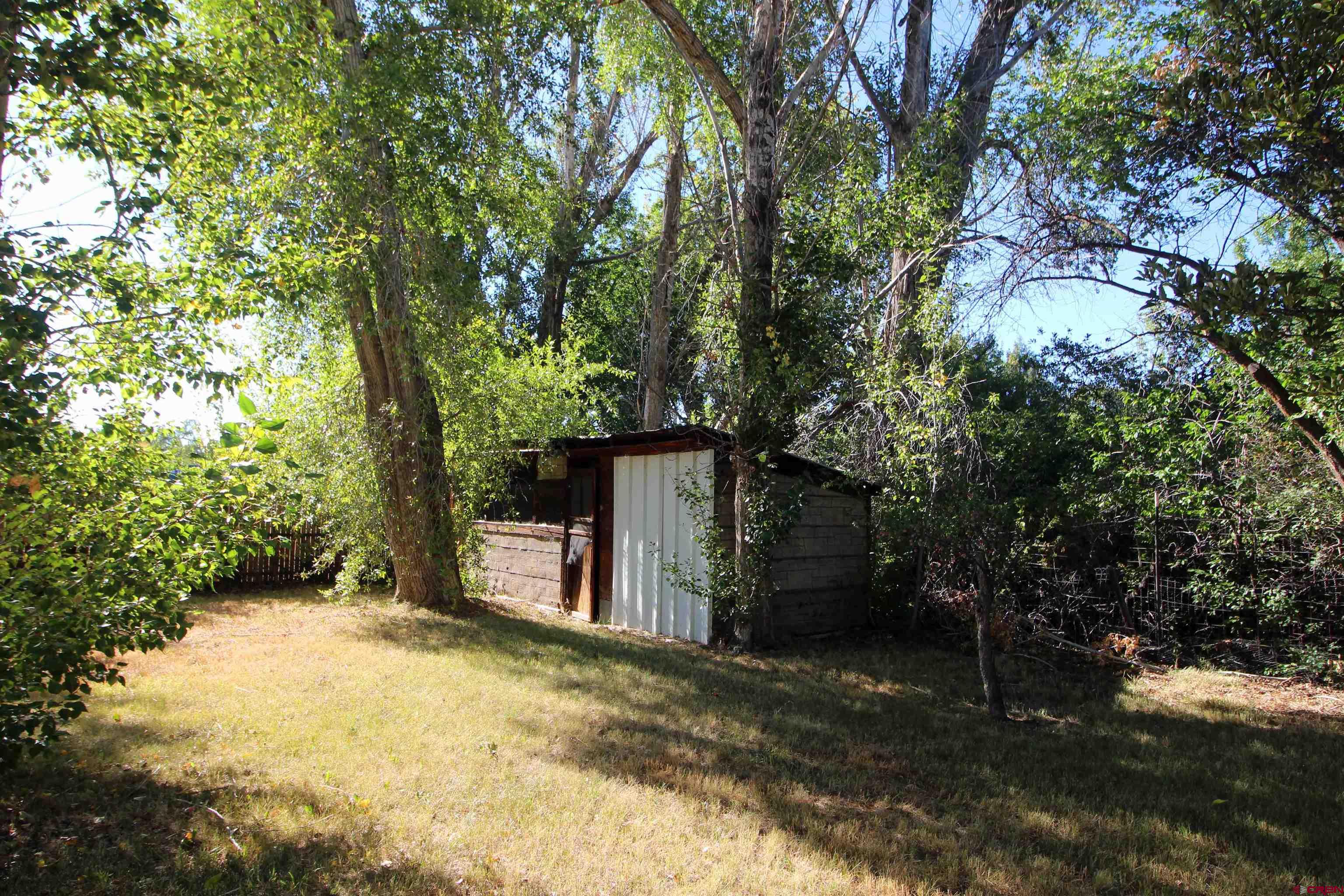 304 South Walnut Street Mancos, CO 81328 - Photo 20 of 31 a backyard of a house with oven and tree
