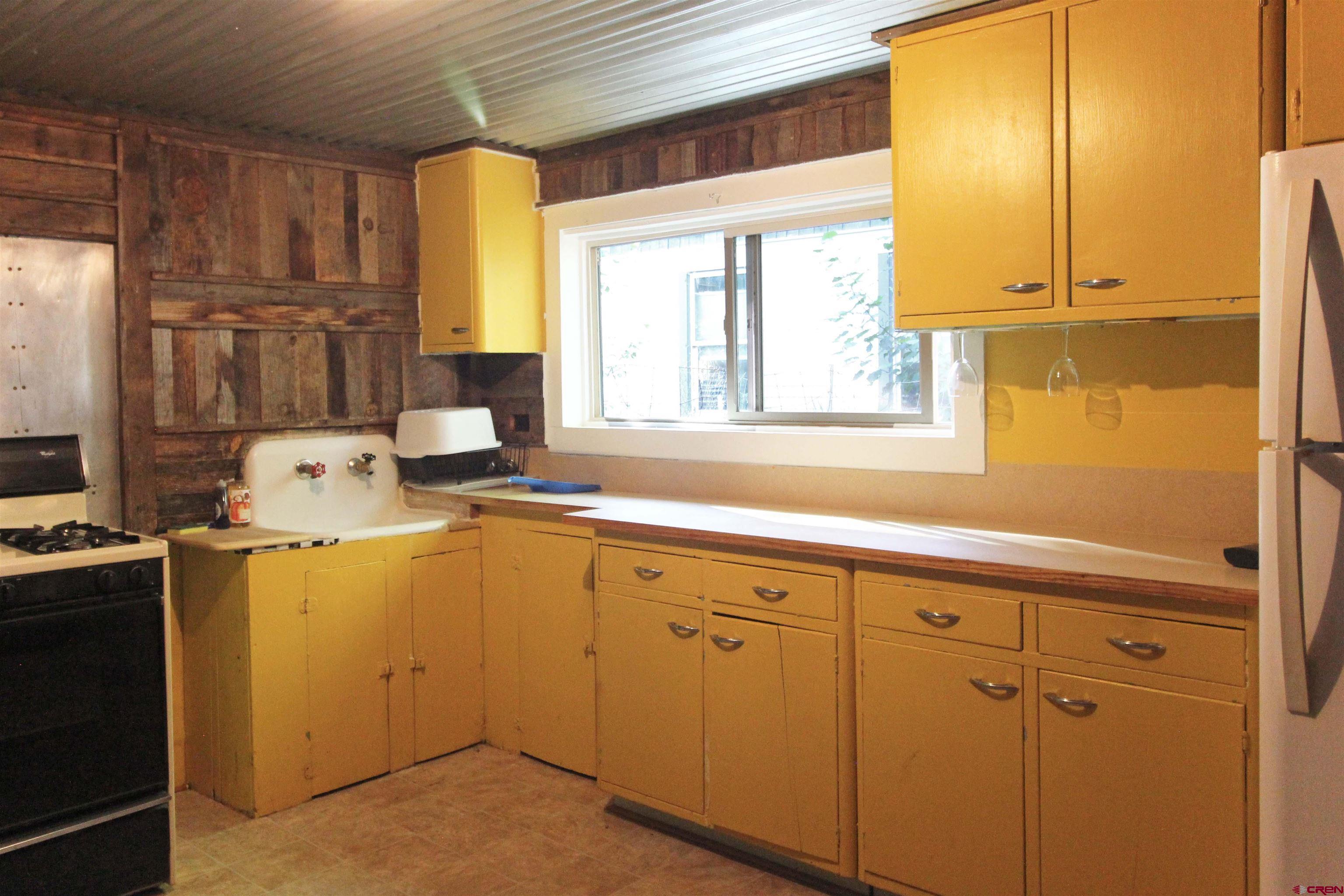 304 South Walnut Street Mancos, CO 81328 - Photo 7 of 31 a utility room with cabinets washer and dryer