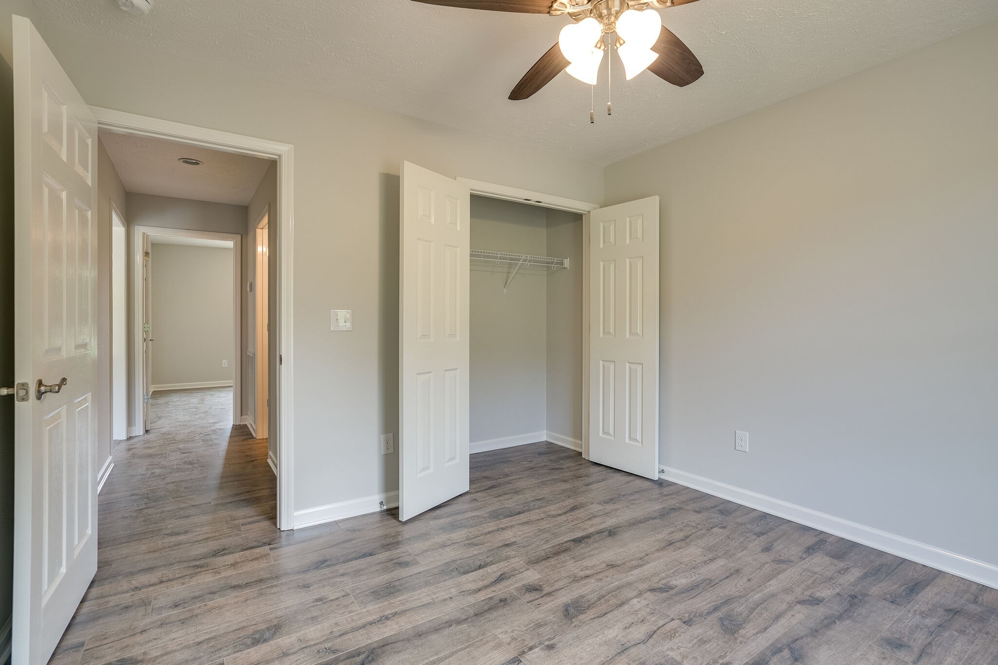 713 Jarrell Road Manchester, TN 37355 - Photo 13 of 25 an empty room with wooden floor chandelier and closet area