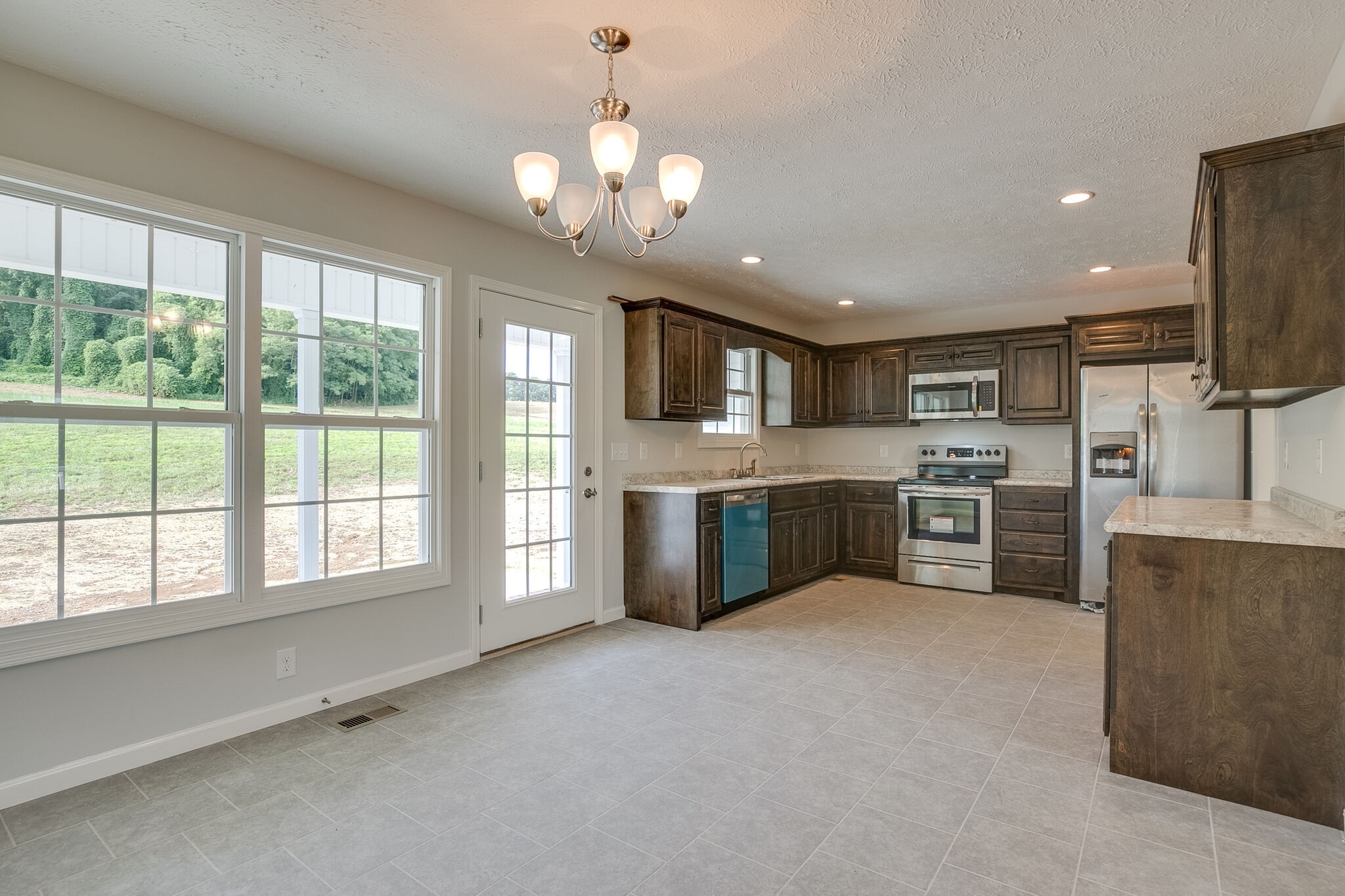 713 Jarrell Road Manchester, TN 37355 - Photo 6 of 25 a large kitchen with a large window and stainless steel appliances
