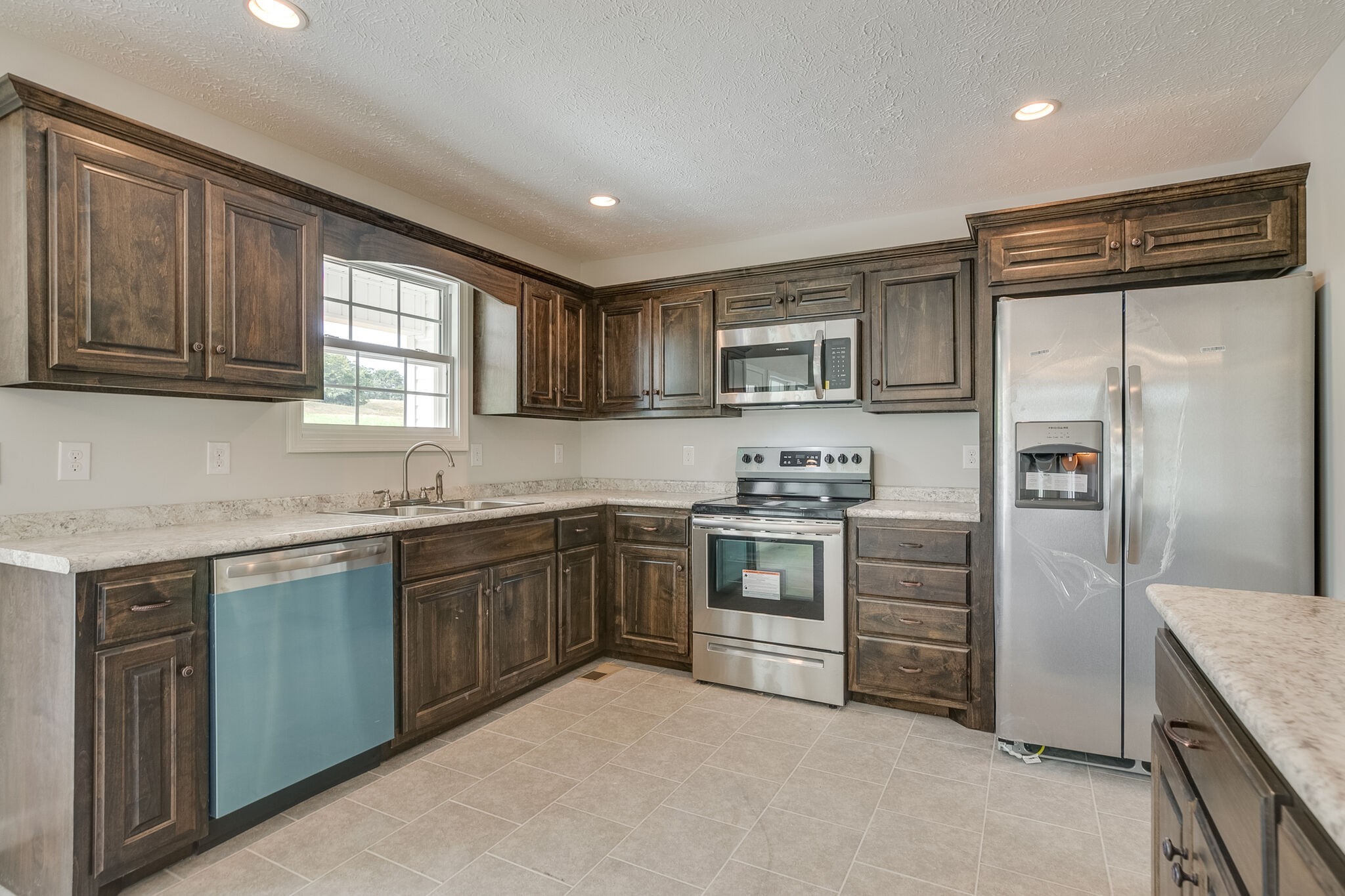 713 Jarrell Road Manchester, TN 37355 - Photo 9 of 25 a kitchen with granite countertop a refrigerator stove top oven and sink