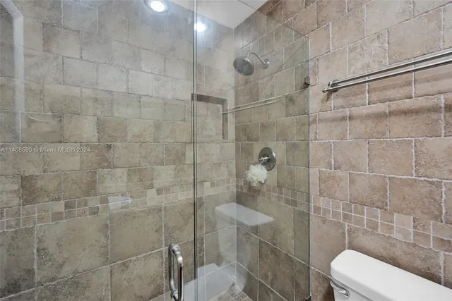 a bathroom with a toilet and a shower
