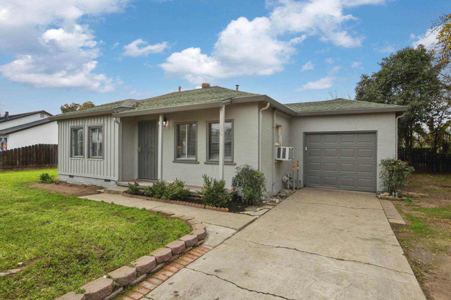 1436 Teresa Street Modesto, CA 95350 - Photo 1 of 32 a front view of a house with garden