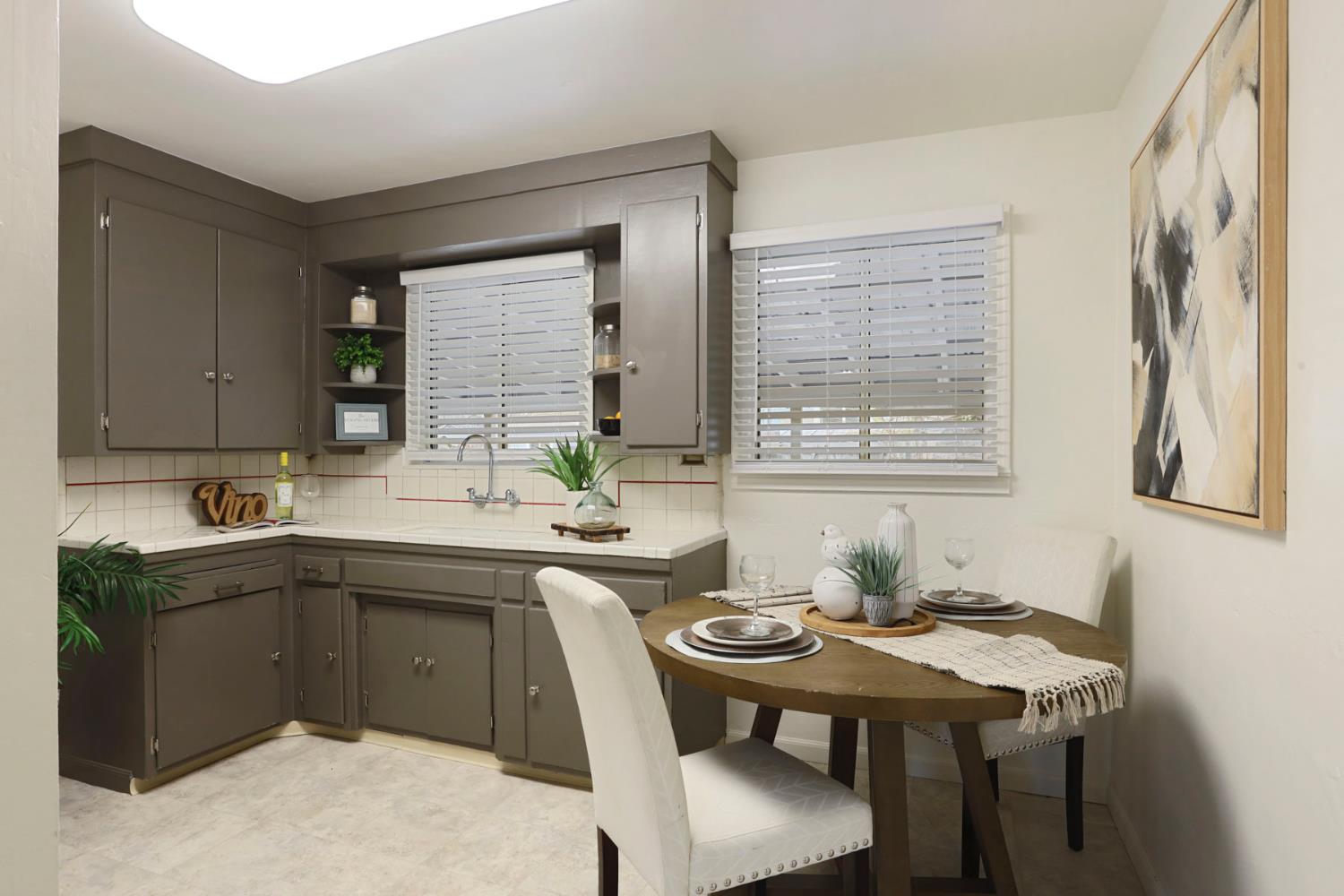 1436 Teresa Street Modesto, CA 95350 - Photo 12 of 32 a kitchen with a table chairs sink and cabinets