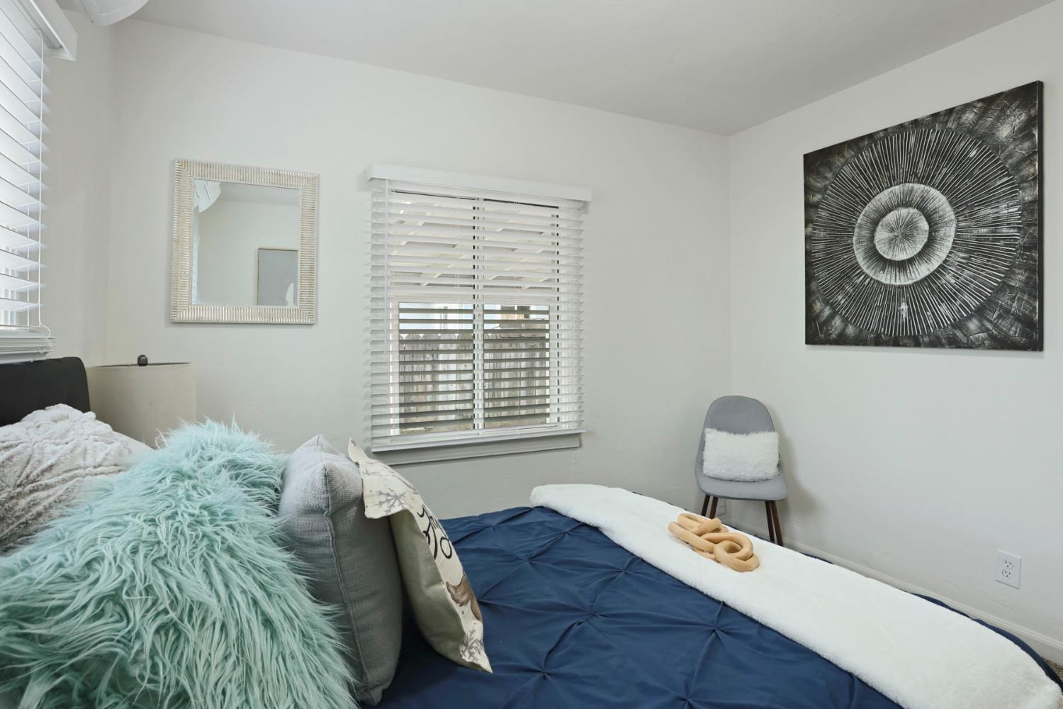 1436 Teresa Street Modesto, CA 95350 - Photo 22 of 32 a bed sitting in a bedroom next to a window and a lamp