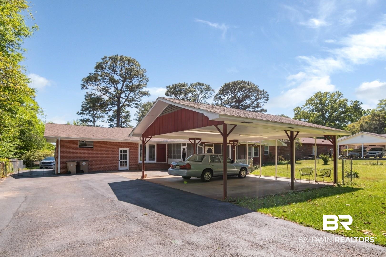 6300 Woodcrest Drive Mobile, AL 36608 - Photo 32 of 35 View of front of property with a front yard, brick siding, and a carport