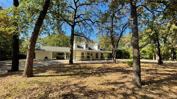 a view of a house with a yard and sitting area