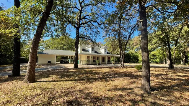 a view of a house with a yard and sitting area