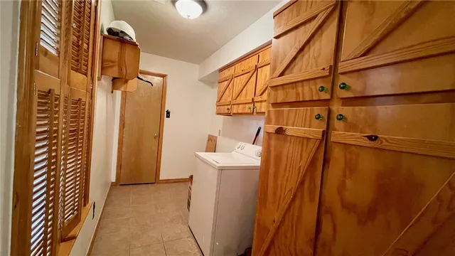 a view of a livingroom with wooden floor and a ceiling fan