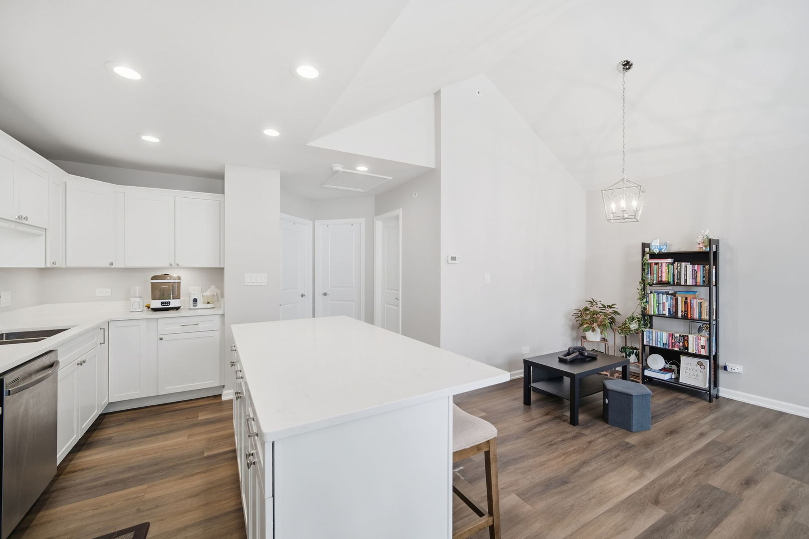 7214 Farmstead Lane Hanover Park, IL 60133 - Photo 12 of 30 a kitchen that has a cabinets and chairs in it