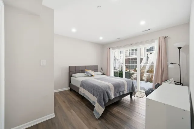 a bedroom with a bed and large window