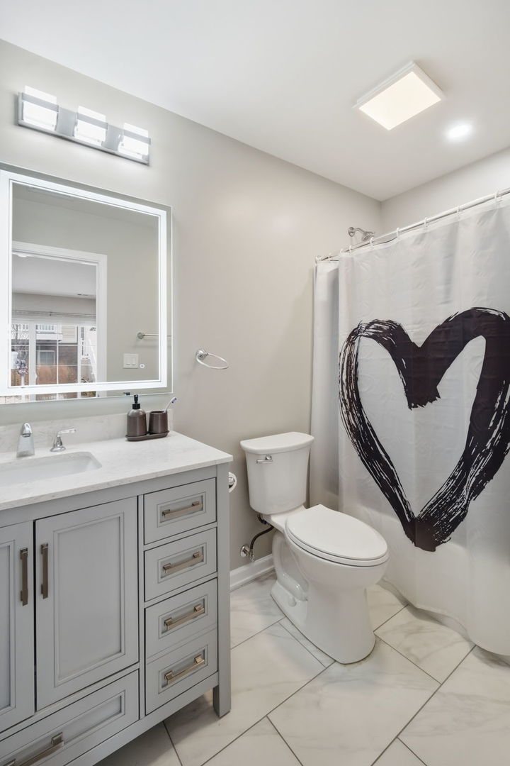 7214 Farmstead Lane Hanover Park, IL 60133 - Photo 18 of 30 a bathroom with a toilet sink and mirror