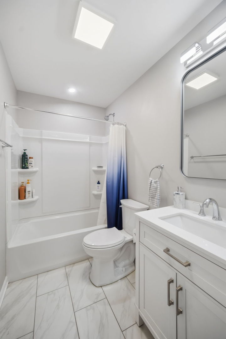 7214 Farmstead Lane Hanover Park, IL 60133 - Photo 20 of 30 a bathroom with a sink a toilet and shower