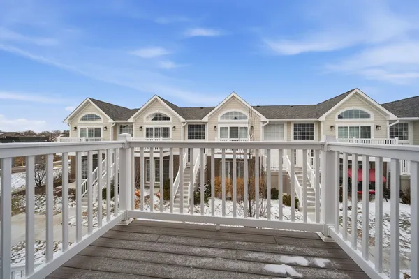 a view of a large house with wooden fence