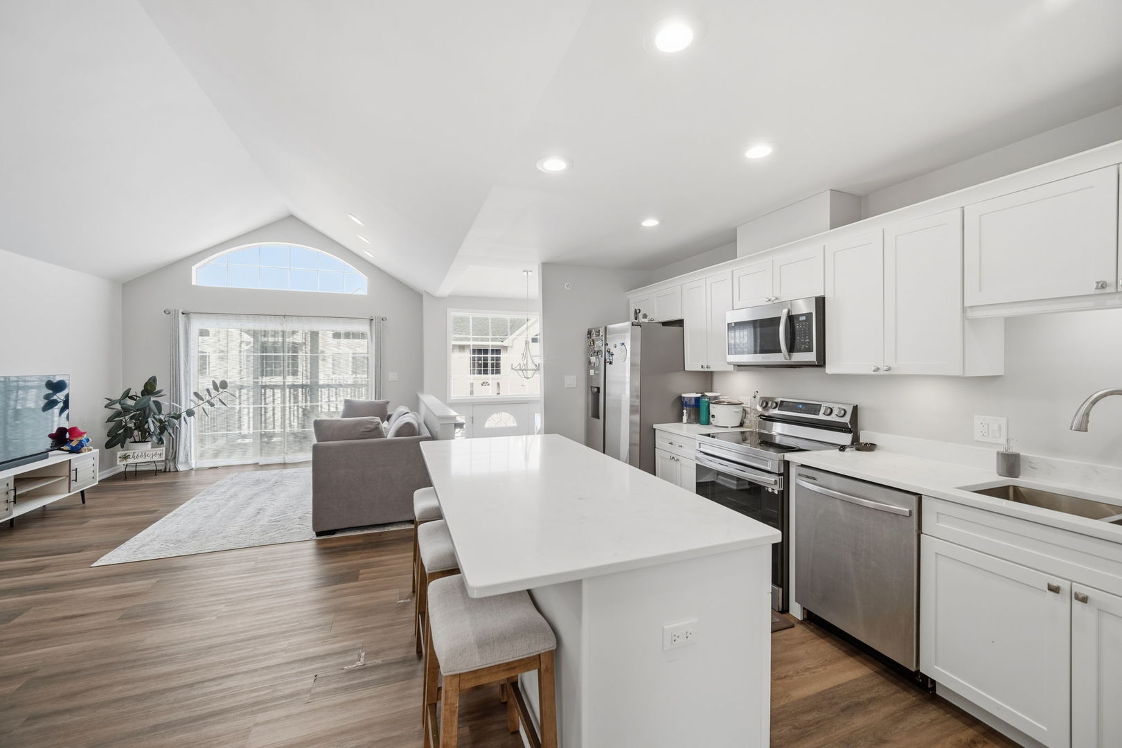 7214 Farmstead Lane Hanover Park, IL 60133 - Photo 4 of 30 a living room with stainless steel appliances furniture a dining table and kitchen view