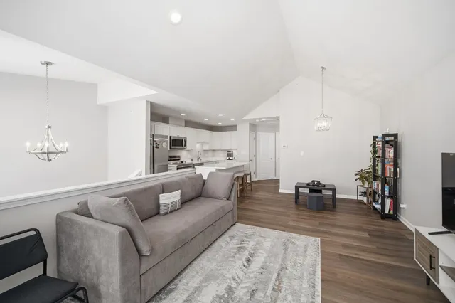 a living room with furniture and view of kitchen