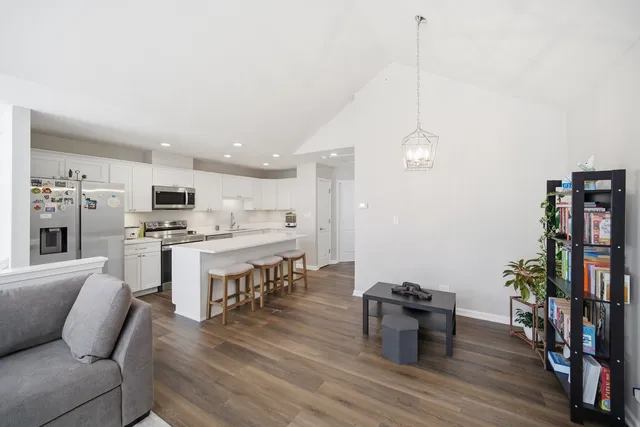 a open kitchen with white cabinets and stainless steel appliances