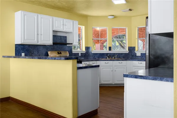 a kitchen with stainless steel appliances a refrigerator sink and microwave